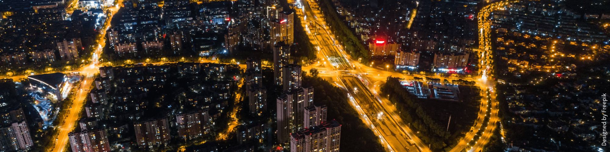 Night time aerial view of a city a lit up at night.